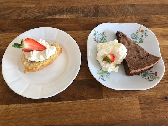 Delicious cake slices with cream and strawberries