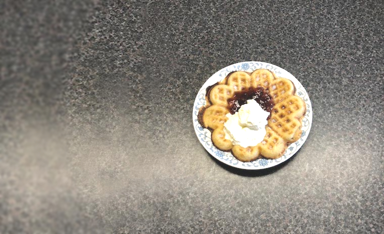 Traditional waffle with cream and jam